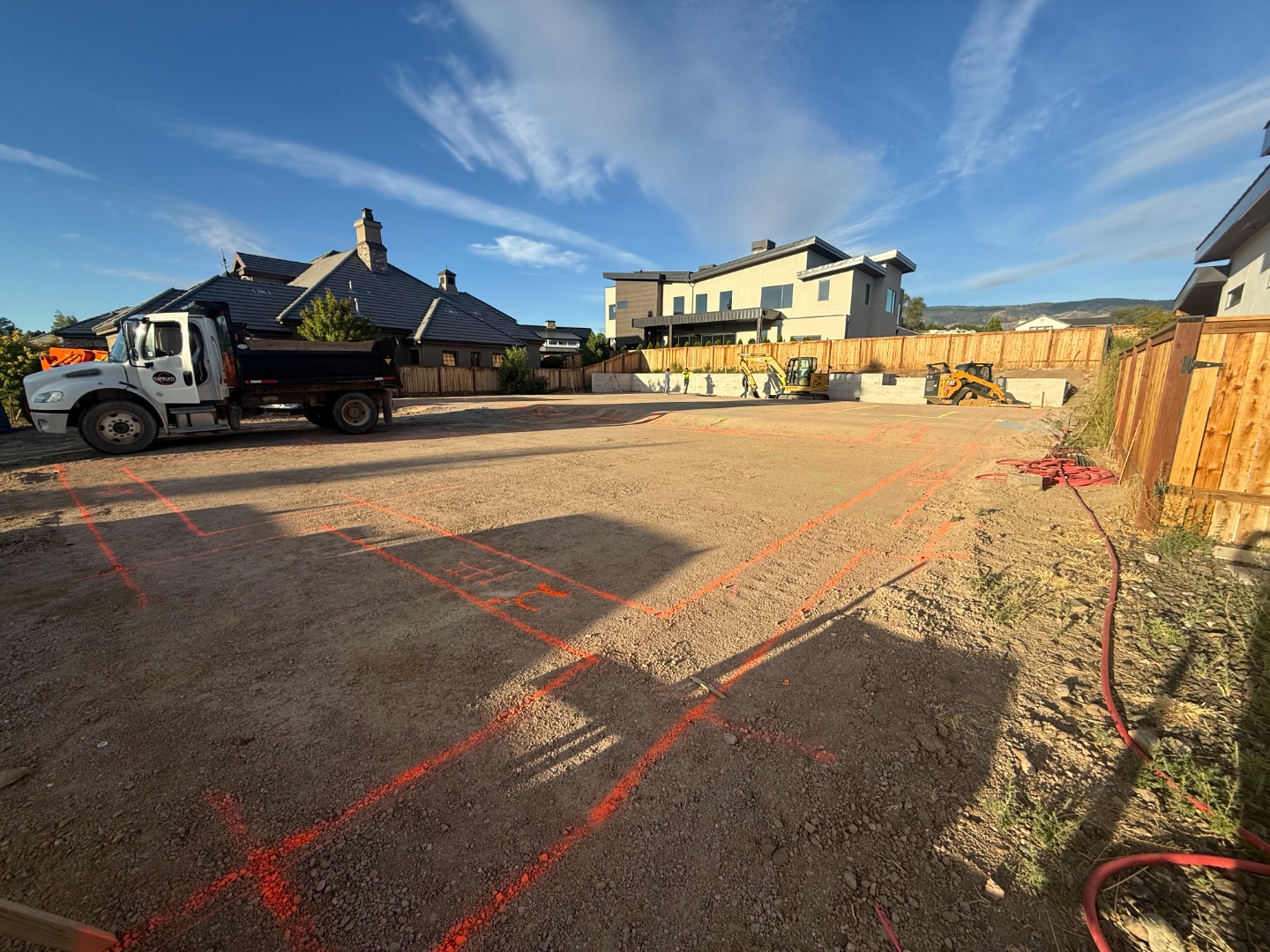 Underslab plumbing and electrical layout marked across the pad