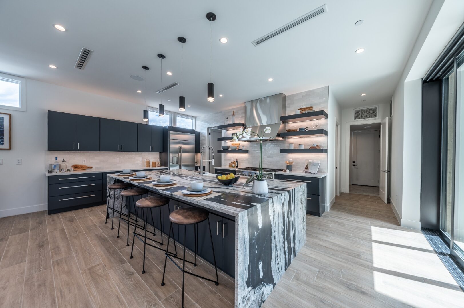 Waterfall island kitchen with blue cabinets