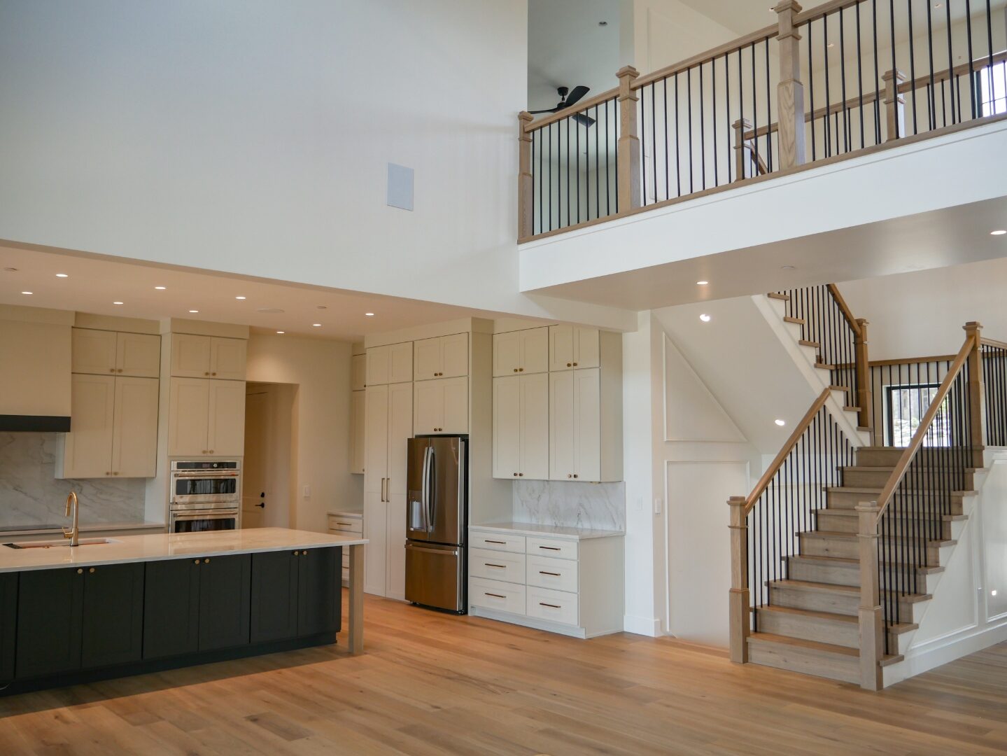 Chef's kitchen with dark island and pantry beyond